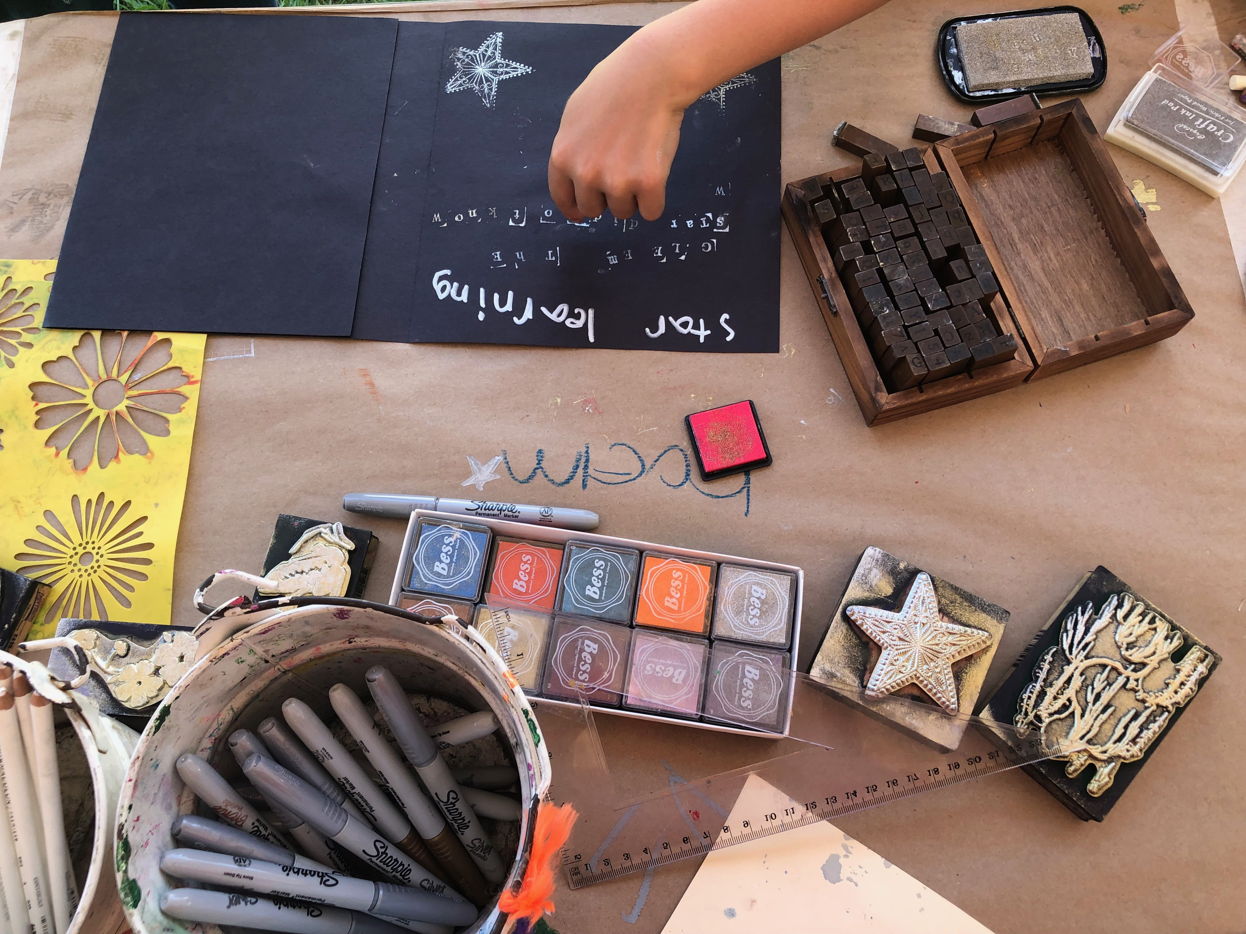 Young artist decorating a book made in teaching artist Jenny Ziomek’s workshop