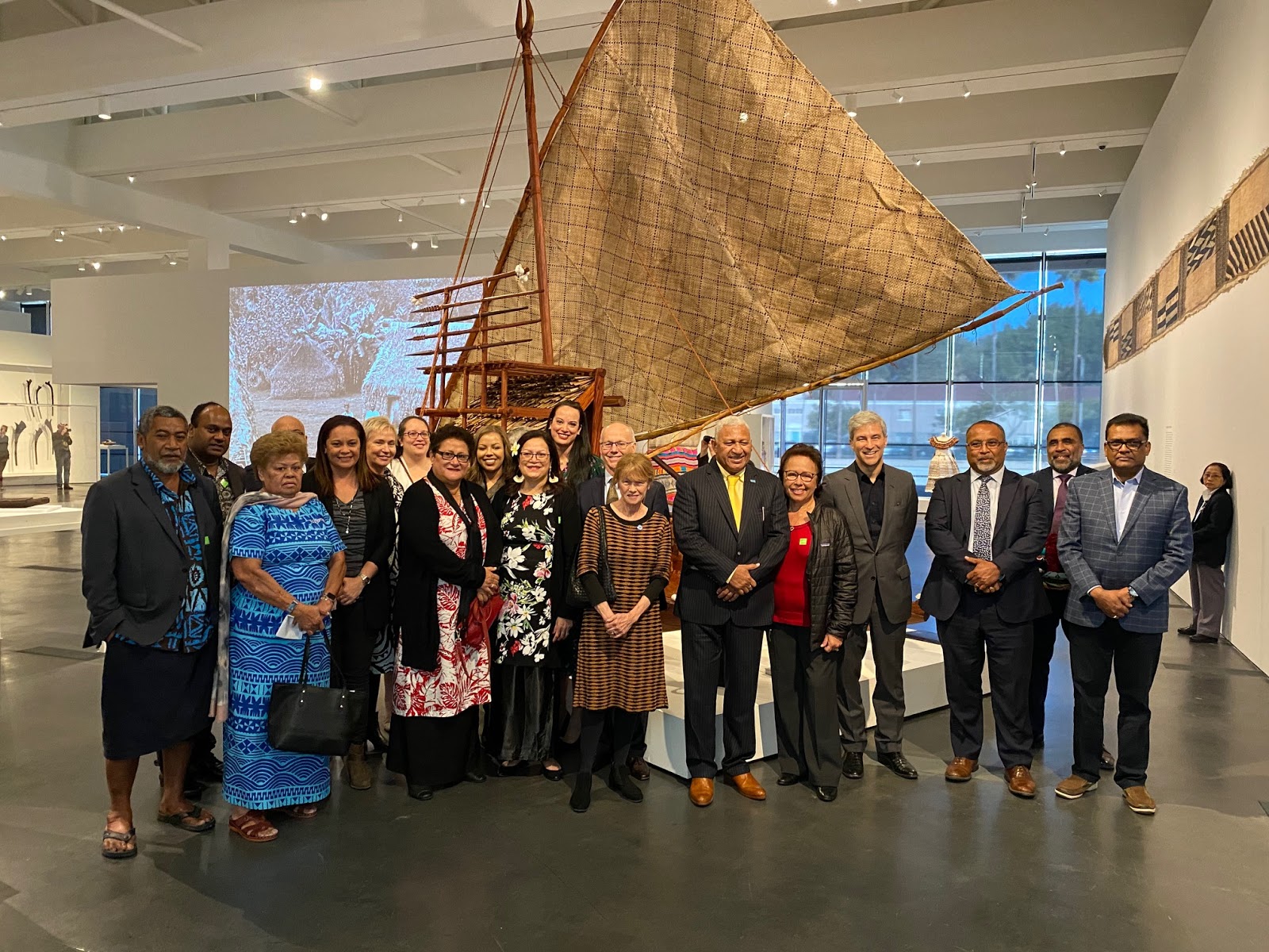 Attendees of the opening ceremony in front of the Fijian drua