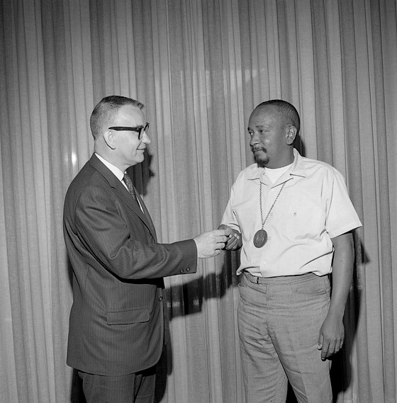 Cecil Fergerson receiving his 20 year plaque from LACMA director Kenneth Donahue