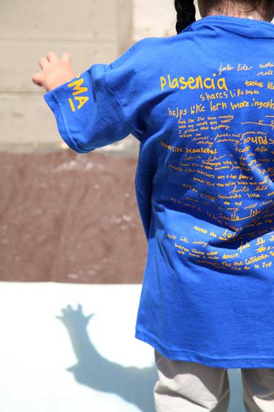 Student wearing limited edition t-shirt and making a sun print photograph during workshop, June, 2008