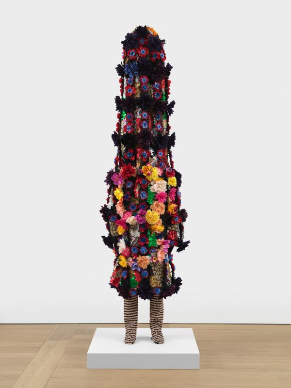 Colorful sculpture with legs and oversized flower-covered body suit