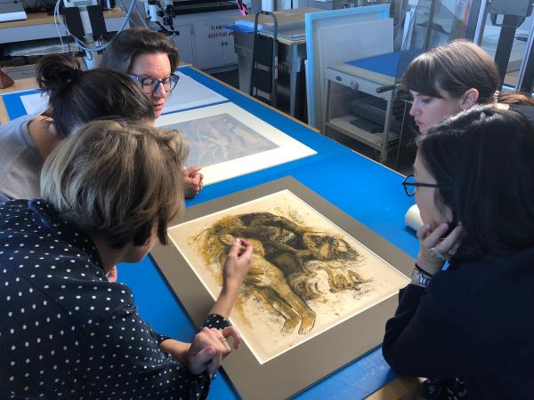 Getty curators Stephanie Schrader and Edina Adam, Getty conservator Michelle Sullivan, and former LACMA (now Getty) curator Naoko Takahatake examine the Gauguin “oil transfer drawing,” image courtesy of Madison Brockman. Foreground: Paul Gauguin, Eve ['The Nightmare'] (recto); Eve ['The Nightmare'] (verso), c. 1899–1900, The J. Paul Getty Museum, Los Angeles; Background: William Blake, Satan Exulting over Eve (detail), 1795, The J. Paul Getty Museum, Los Angeles