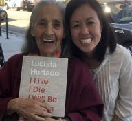 Luchita Hurtado and curator Jennifer King with the catalogue for I Live I Die I Will Be Reborn