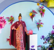 Woman posing in floral installation