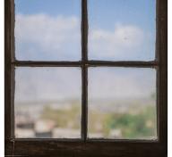 photograph of a window, looking out toward a blue sky