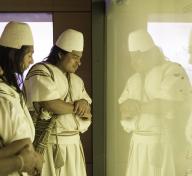 Members of the Arhuaco community looking at Tairona objects in the Museo del Oro Santa Marta