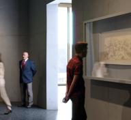 Rendering of visitors viewing Asian scrolls in a gallery